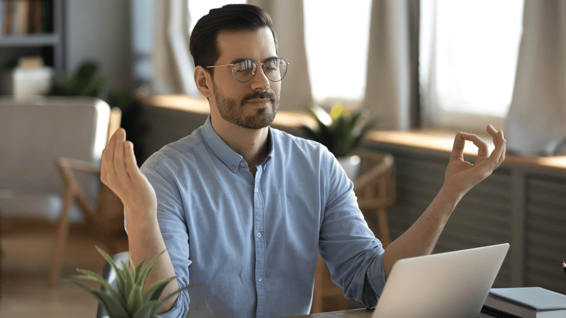 man meditating while working 