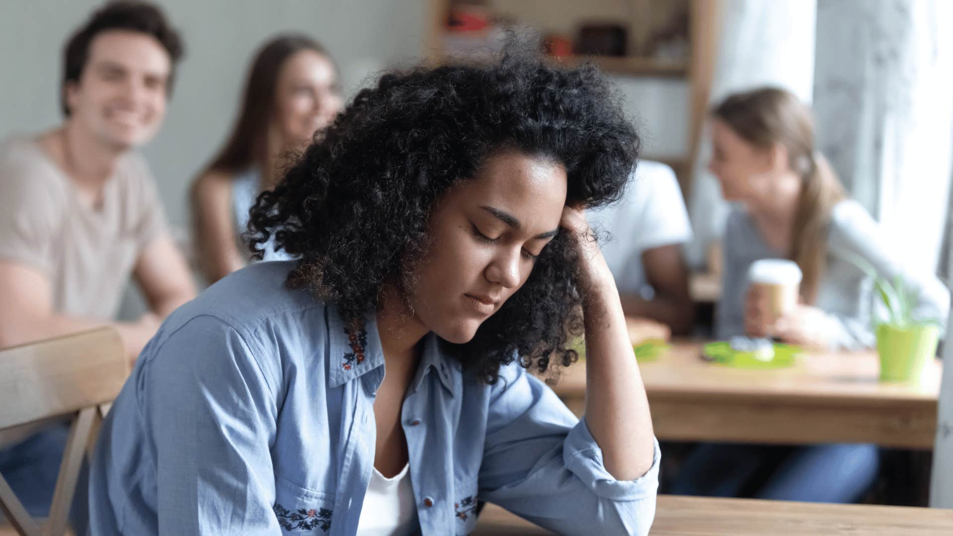 sad woman turned away from group