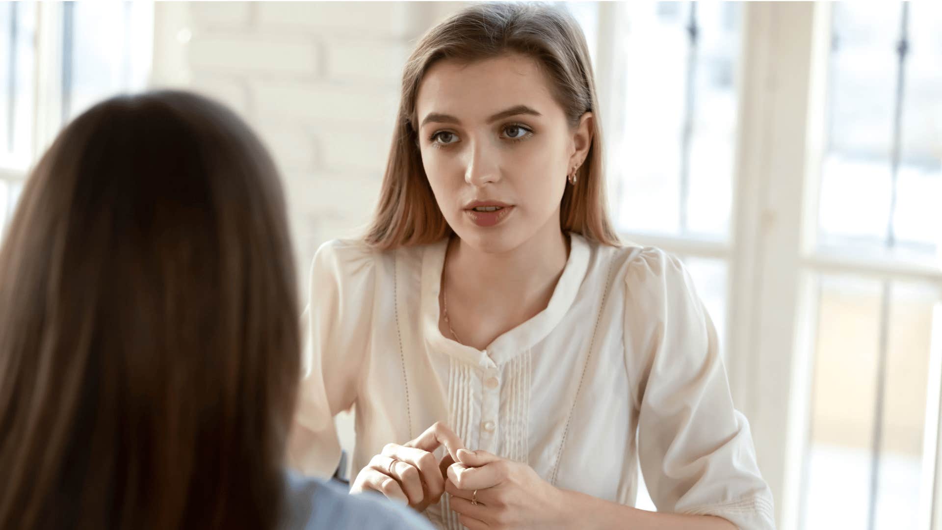 insecure woman apologizing to friend