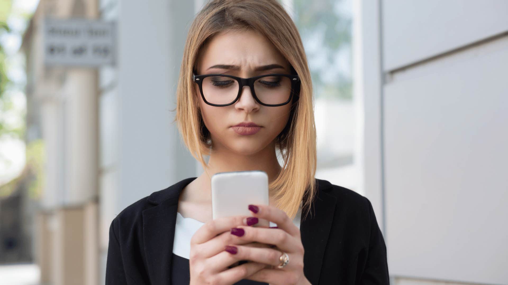 sad woman looking at her phone