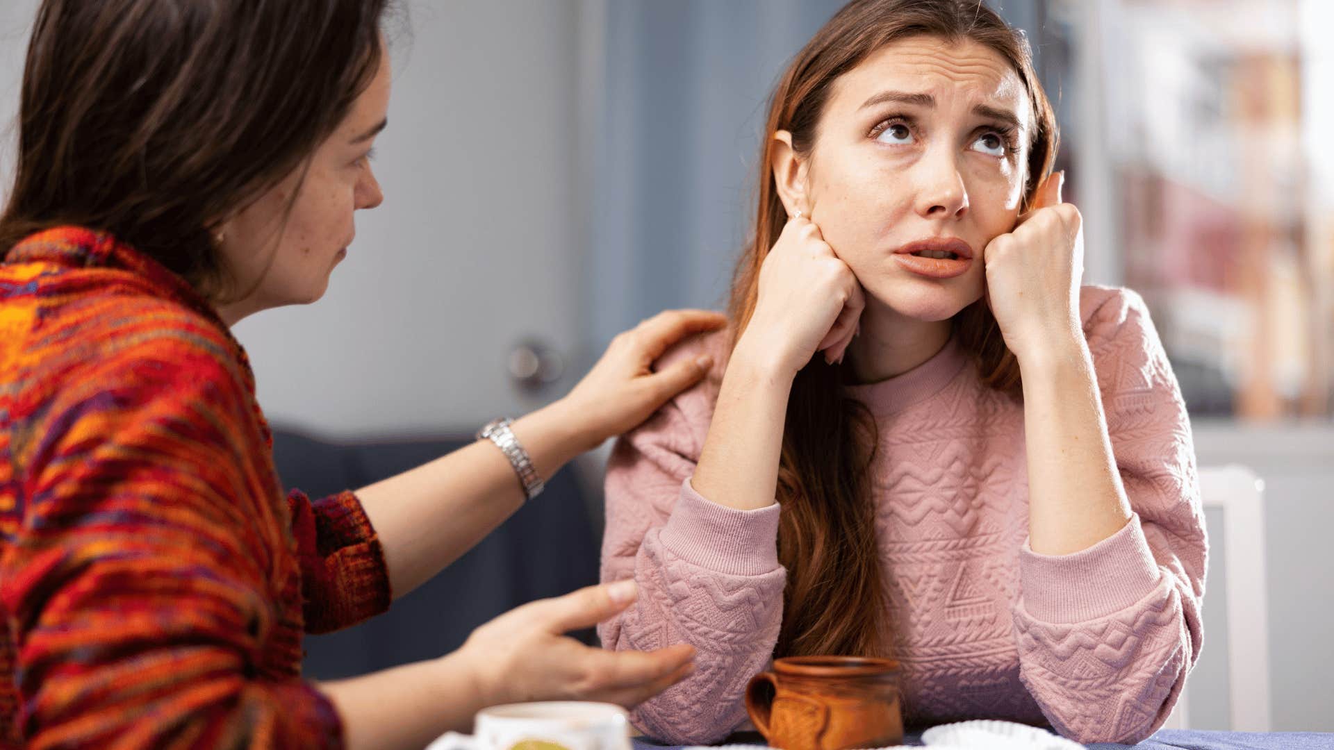 woman trying to comfort her upset friend