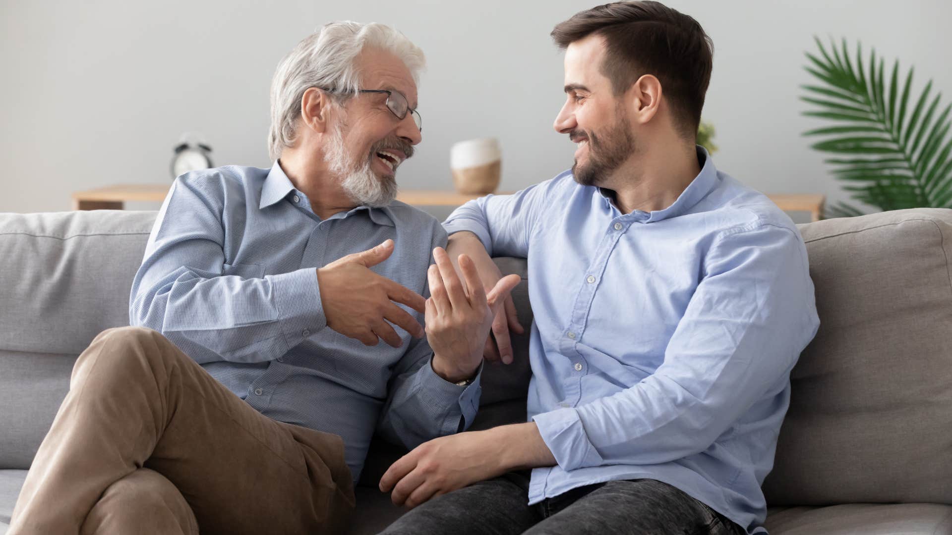 Dad having a happy conversation with his adult son