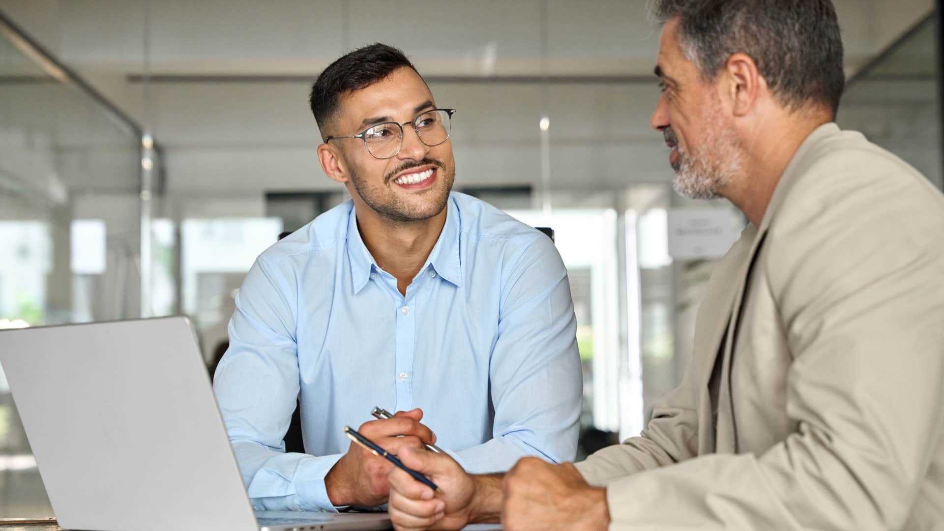 Two men talking to each other at work