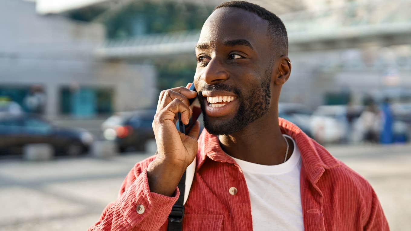 Man smiling and talking on the phone.