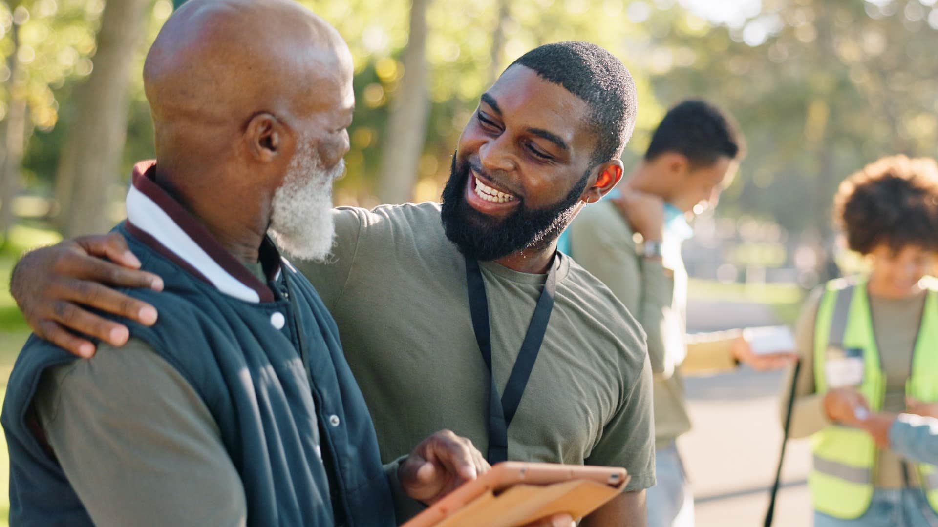 Man hugging his adult son and smiling