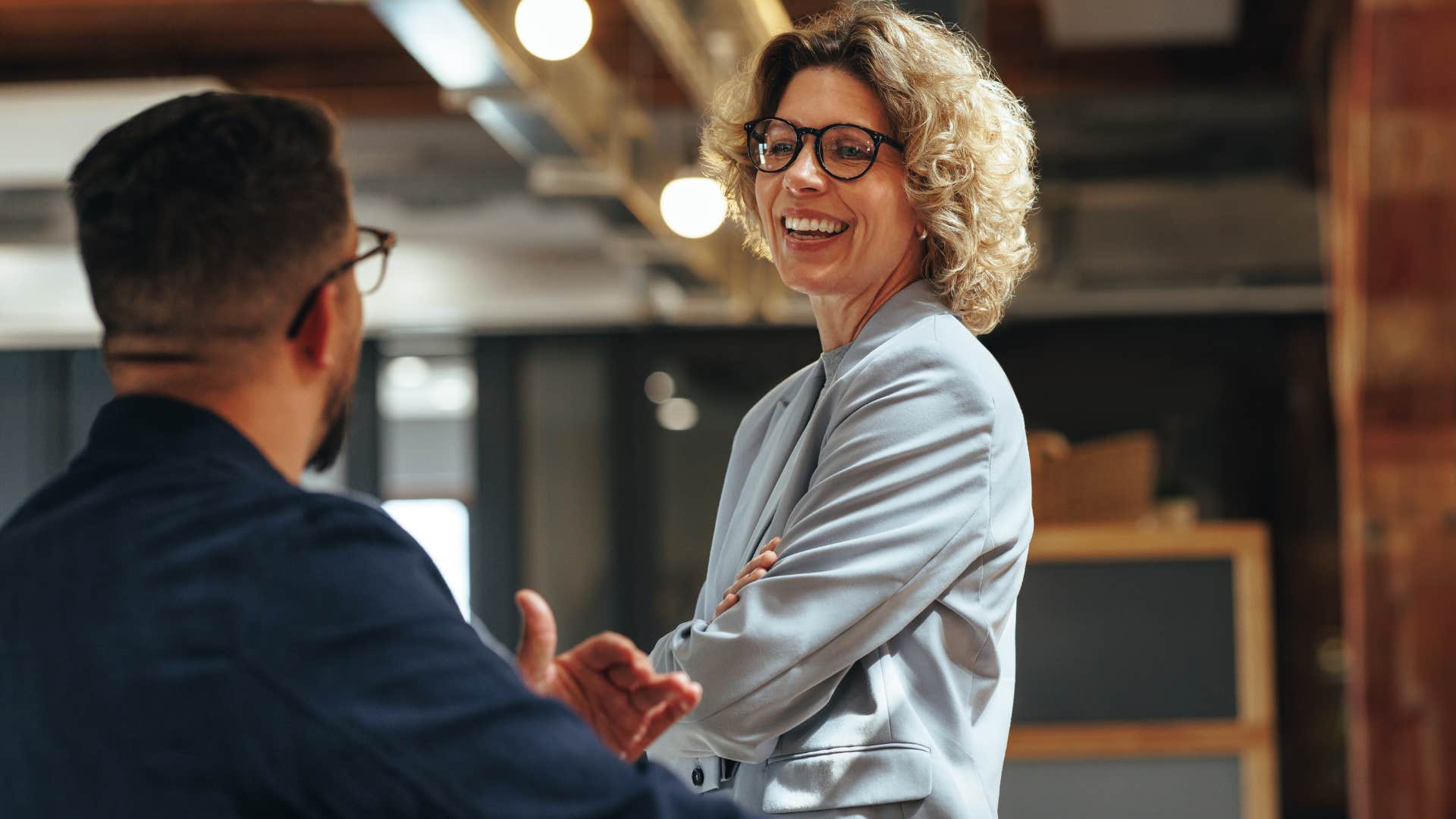 Woman smiling and talking to her co-worker