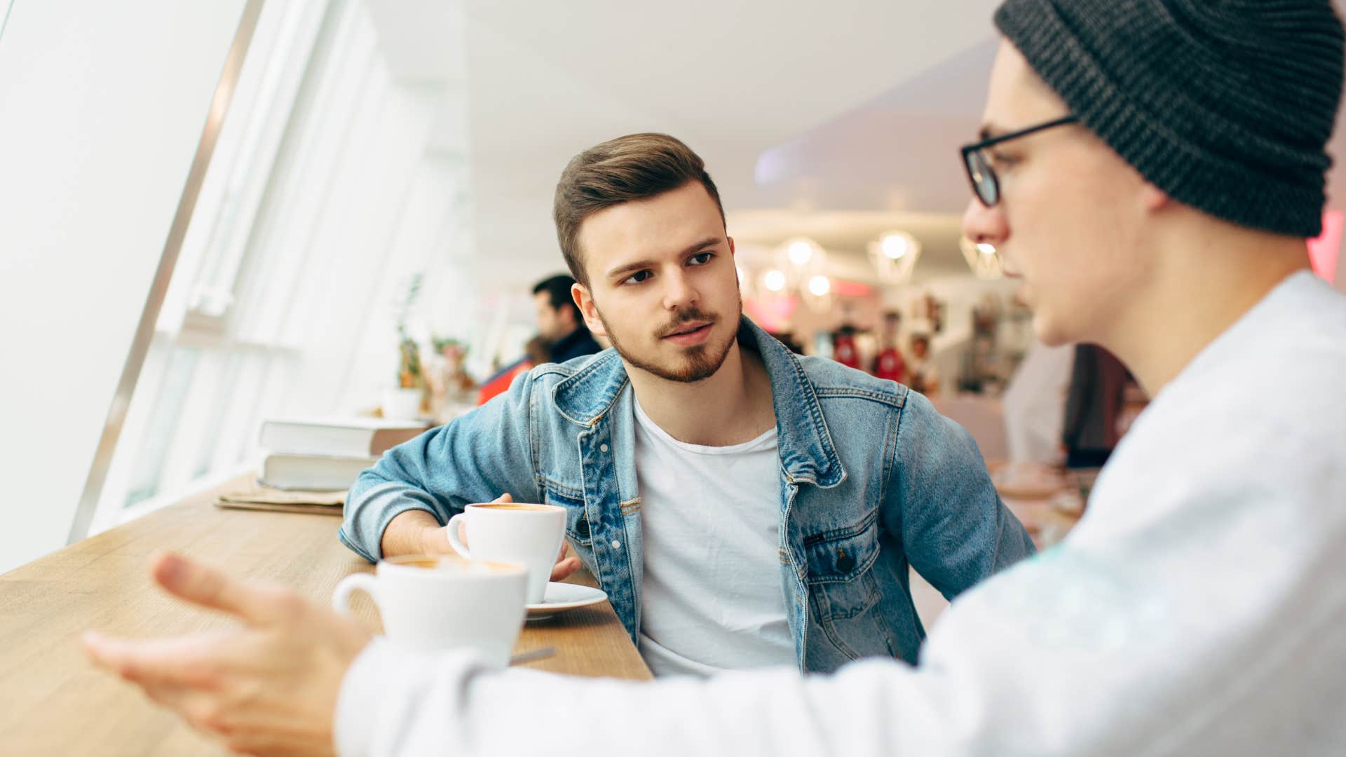 Two men arguing at a coffee shop