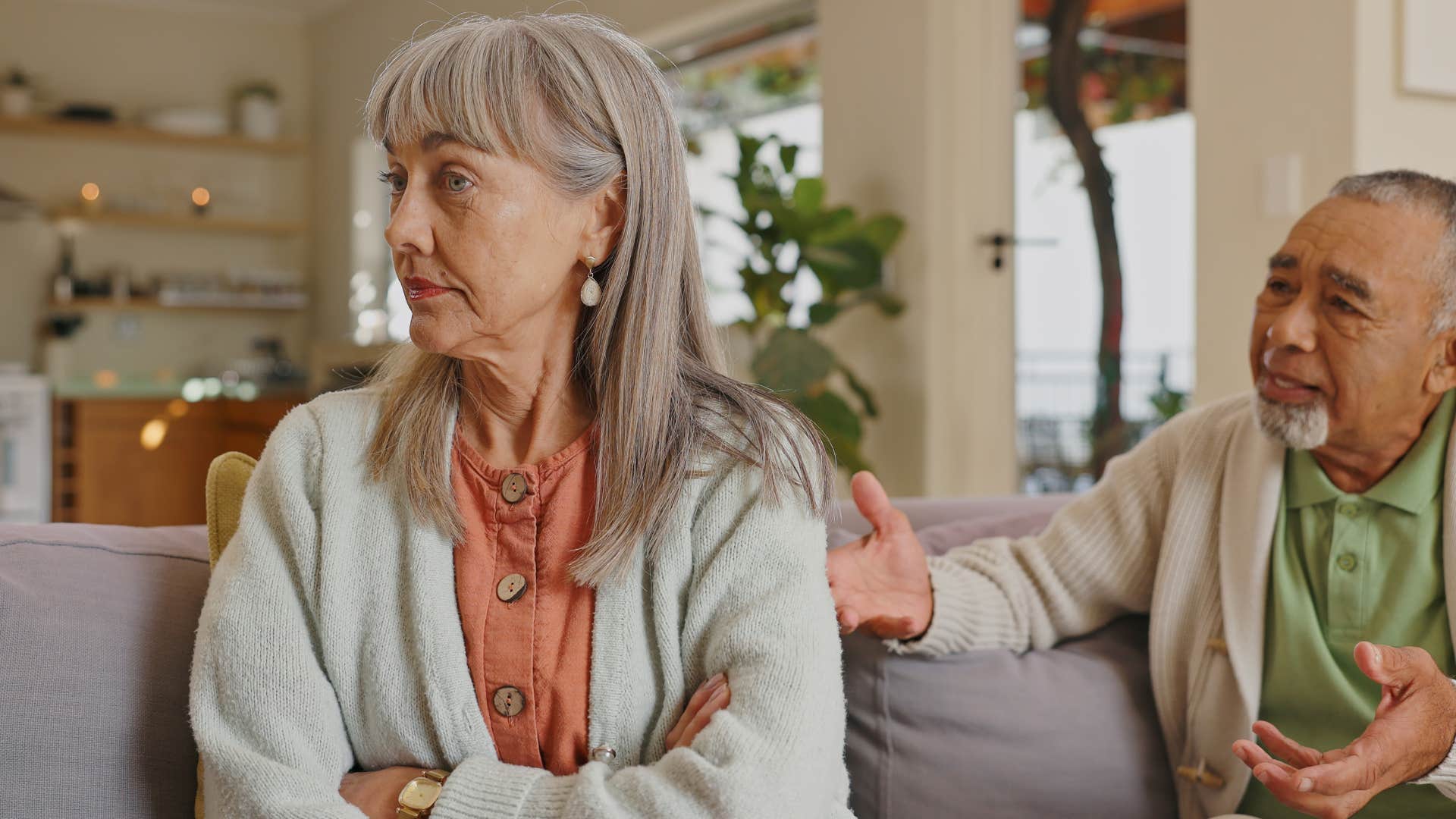 Older woman turned away from her upset partner