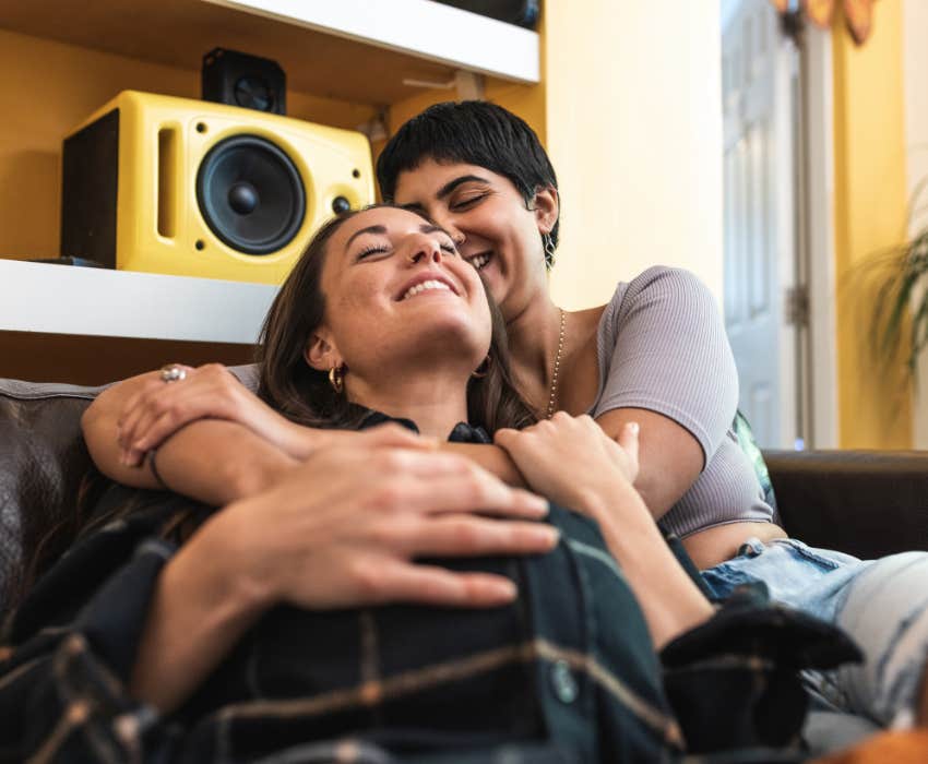 happy couple on sofa at 1-year mark of relationship 