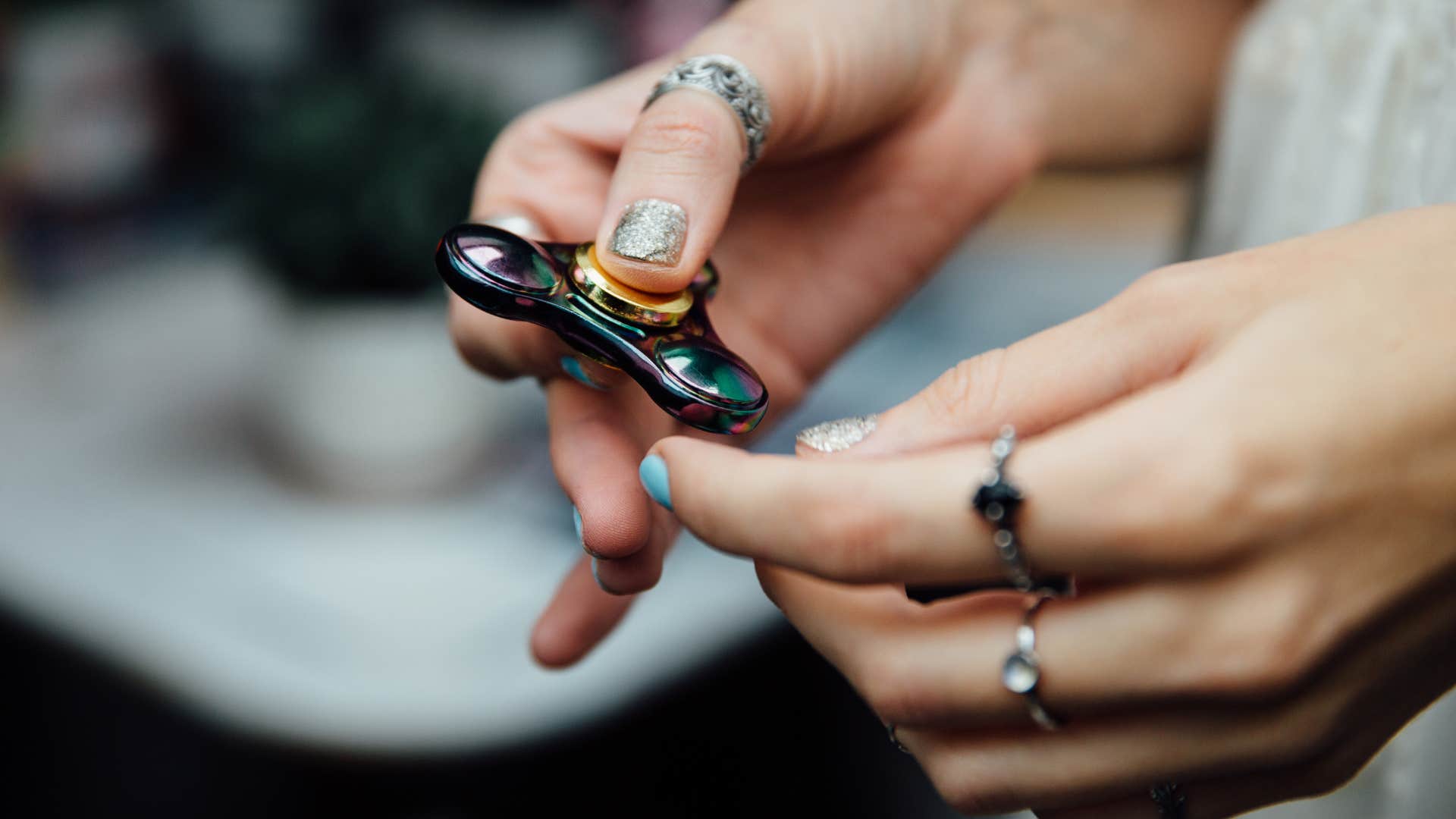 woman's hand with fidget spinner.