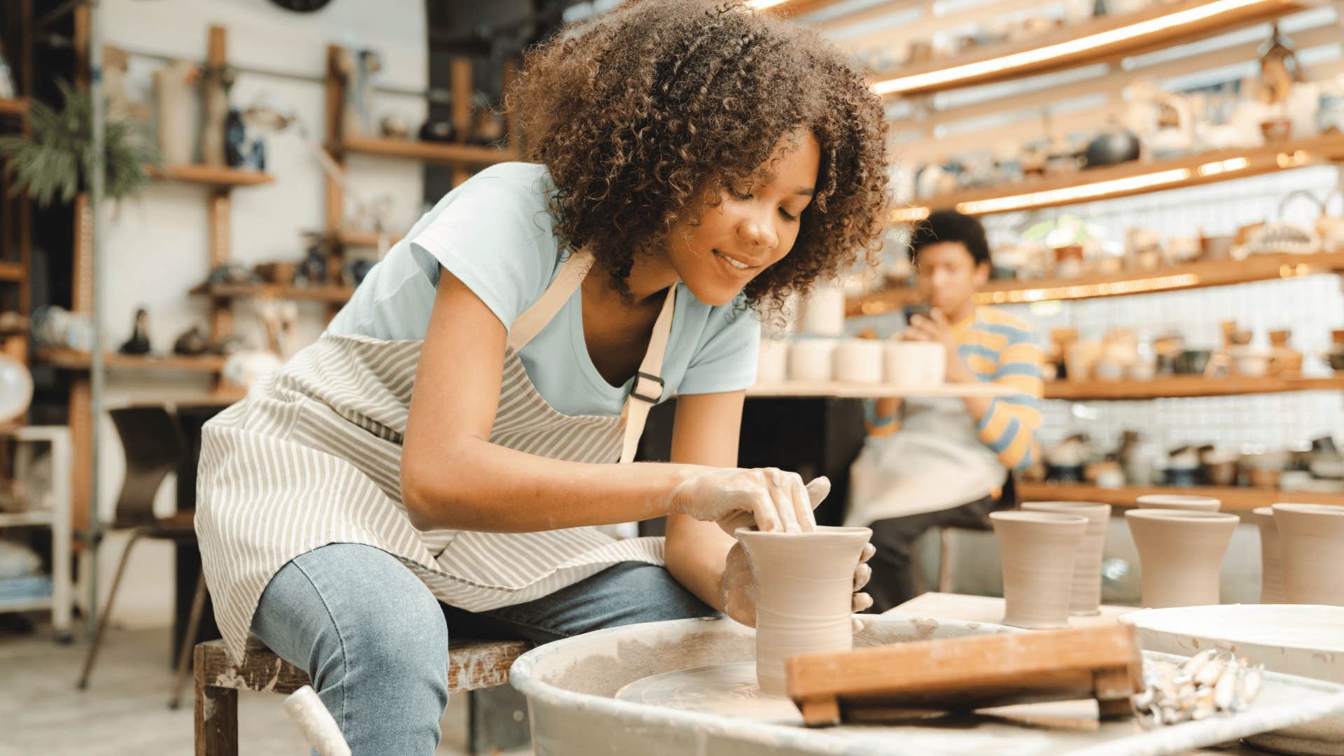 creative woman sculpting clay