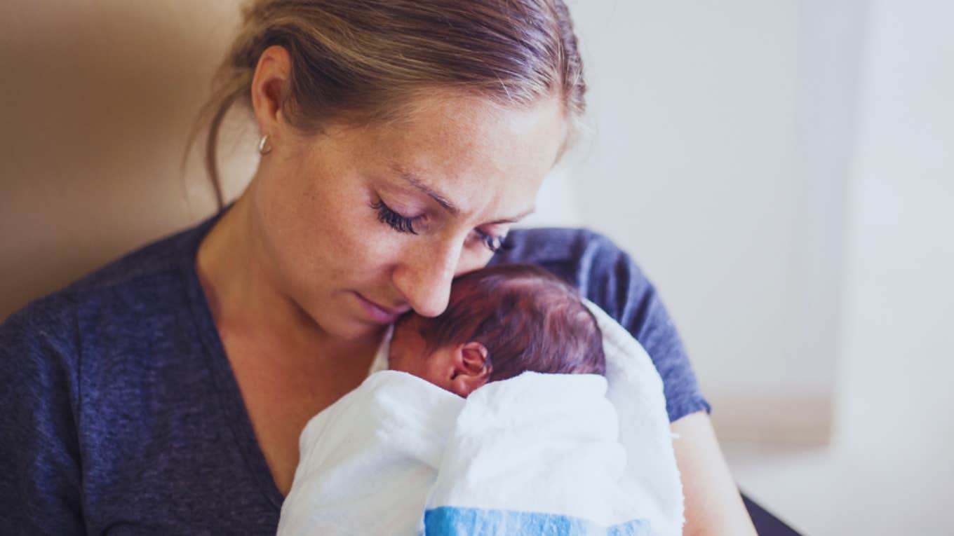 woman holding premature baby 