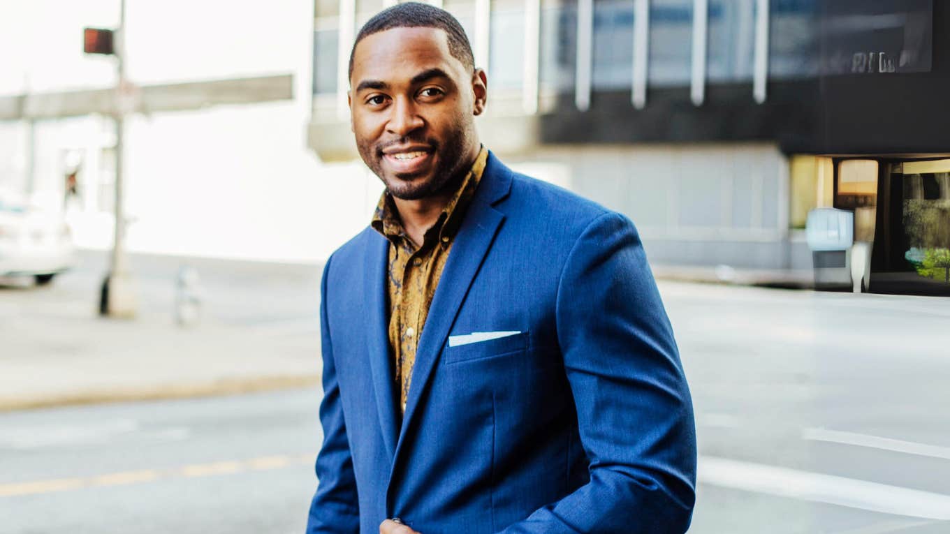 Successful man, smiling while on his way to work.