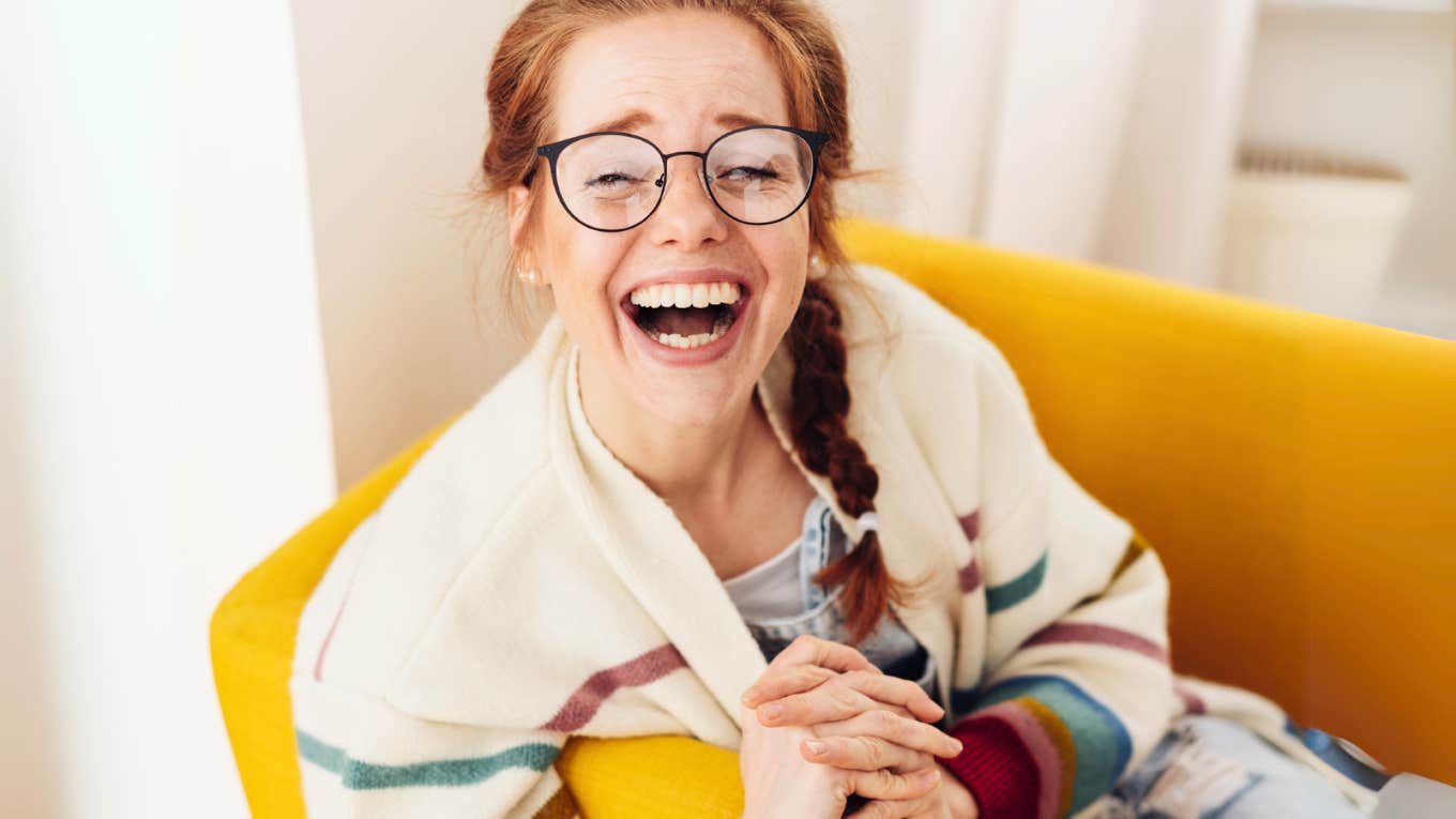 Woman mastering social skills, smiling while leaning into the conversation.