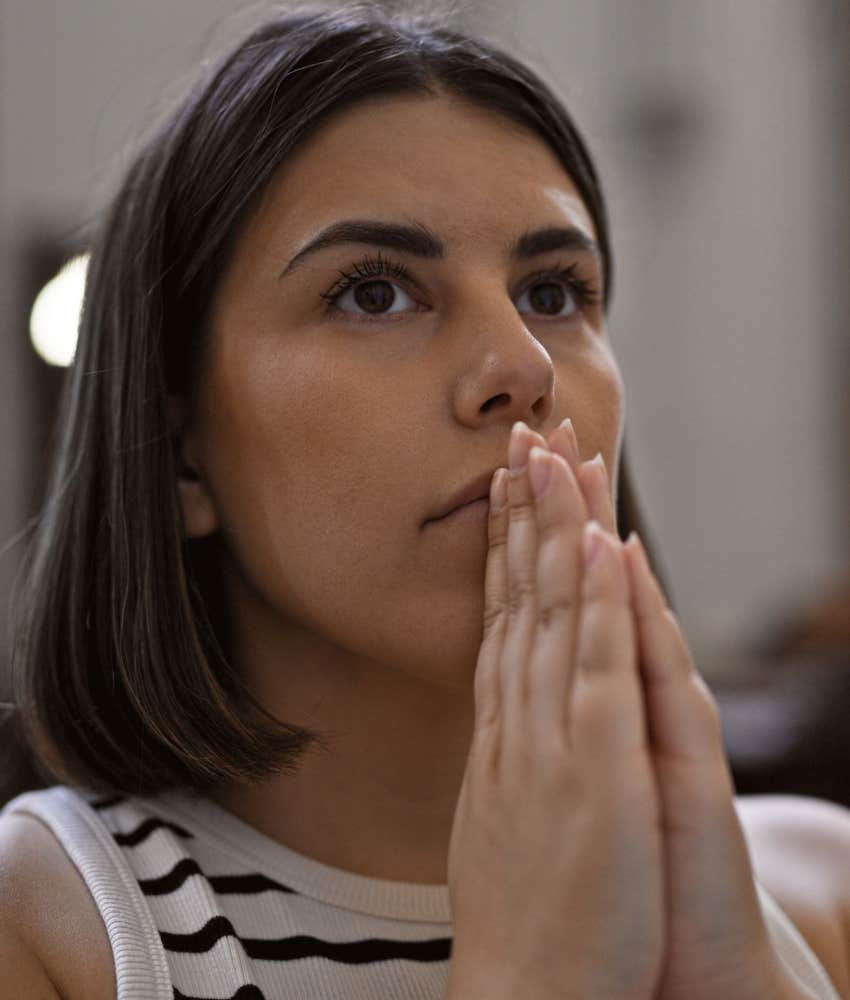 Young woman praying at Church in Vienna