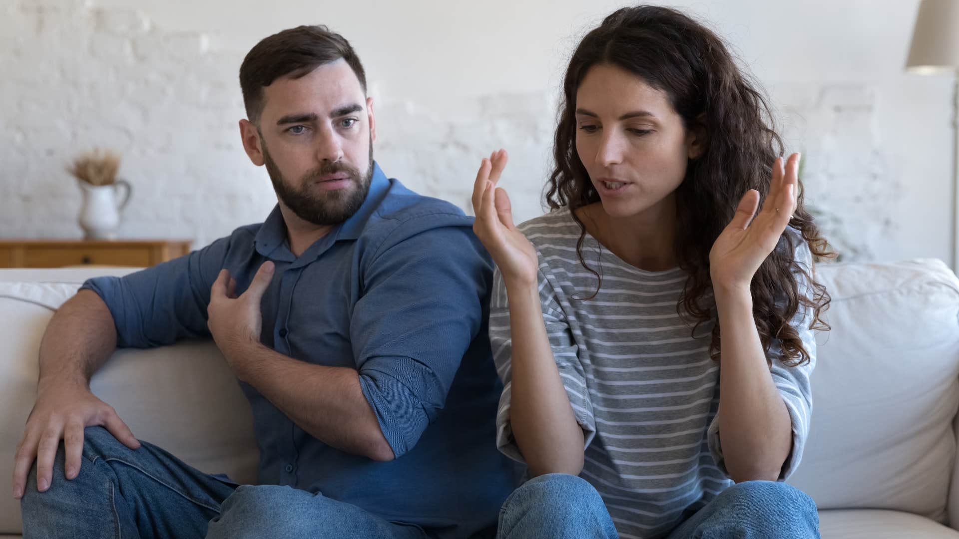 Woman looking annoyed sitting next to her partner.