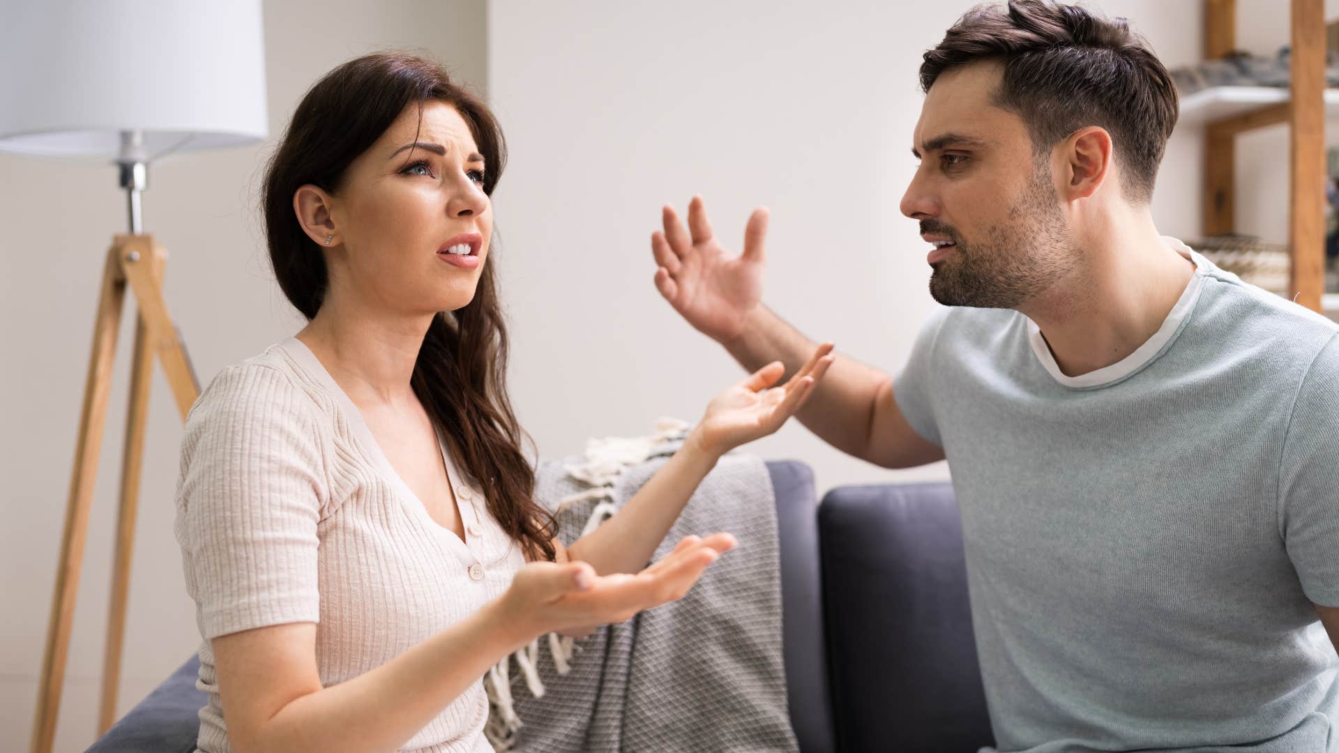 Couple arguing together at home.