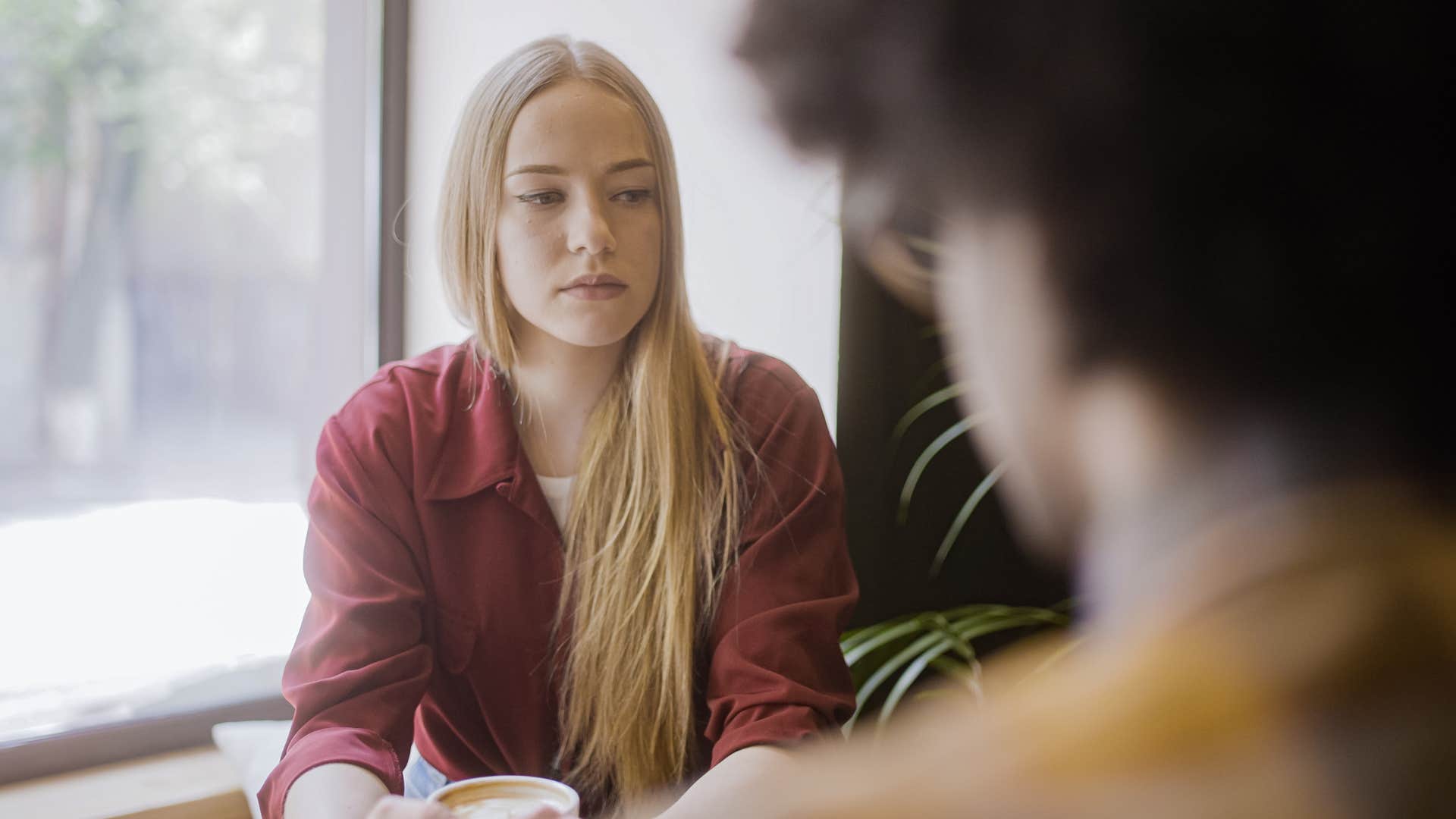 Woman looking sad talking to her partner.