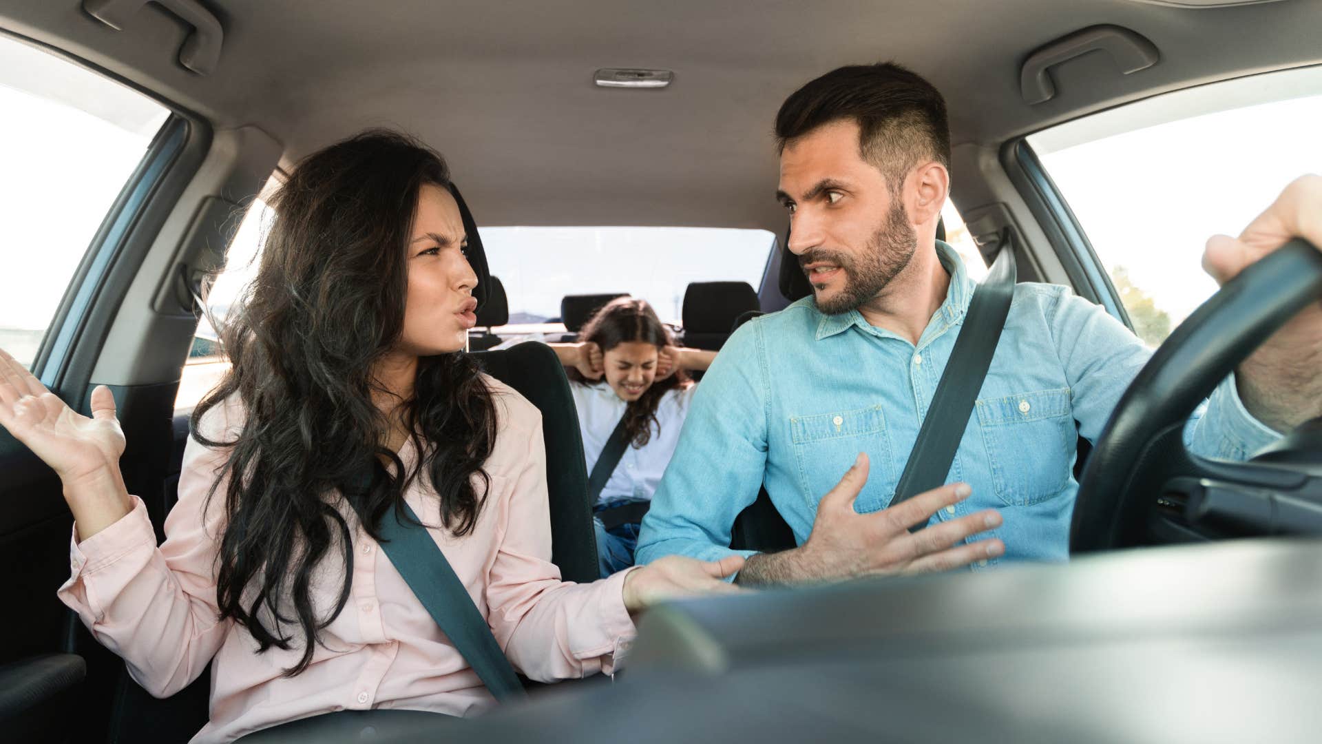 Couple arguing in their car.