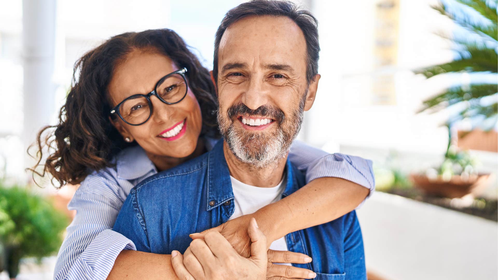 woman hugging her smiling husband