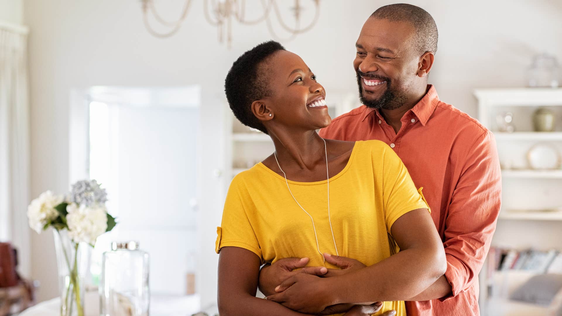 man hugging his smiling wife