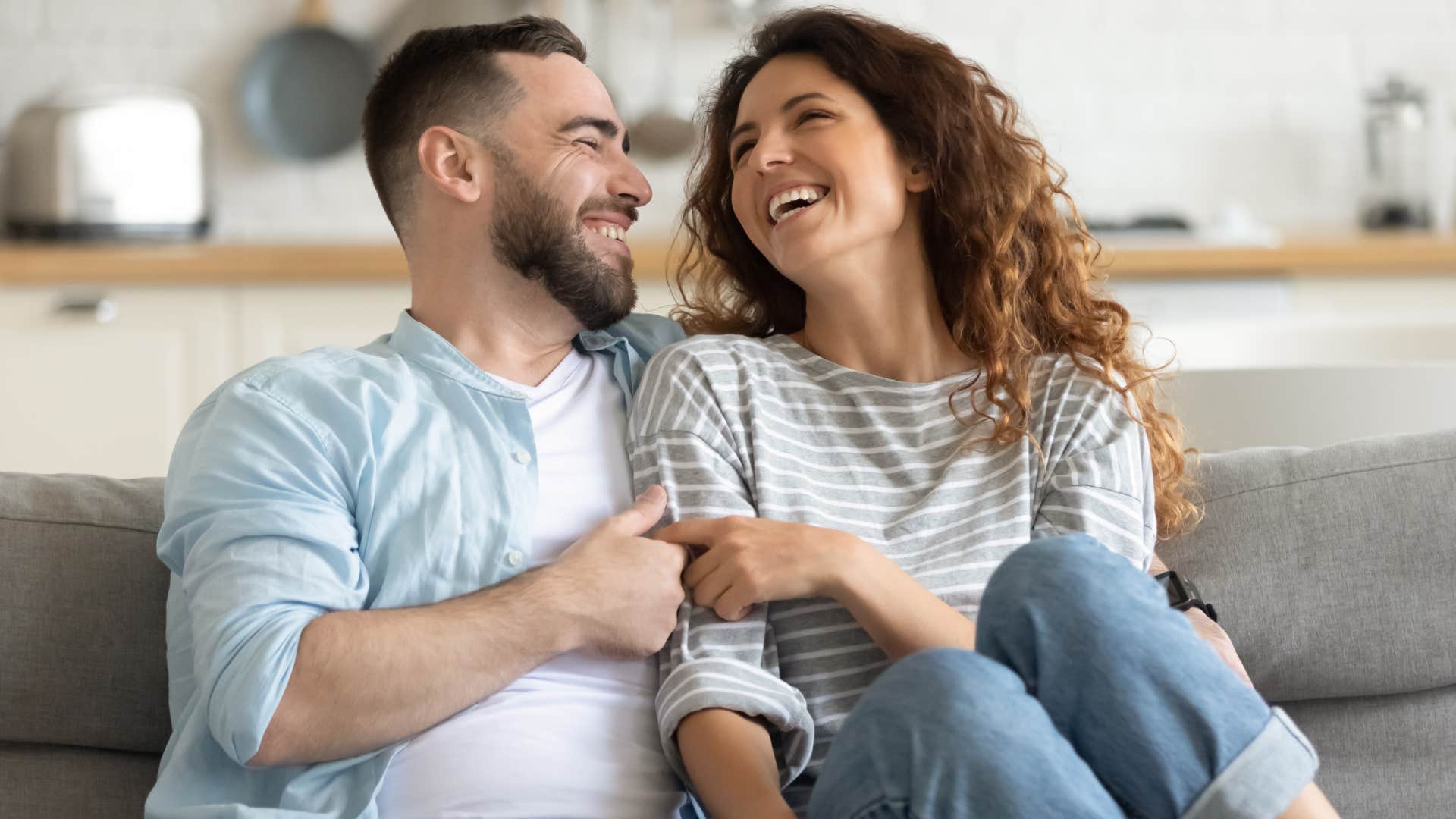 woman encouraging smiling husband