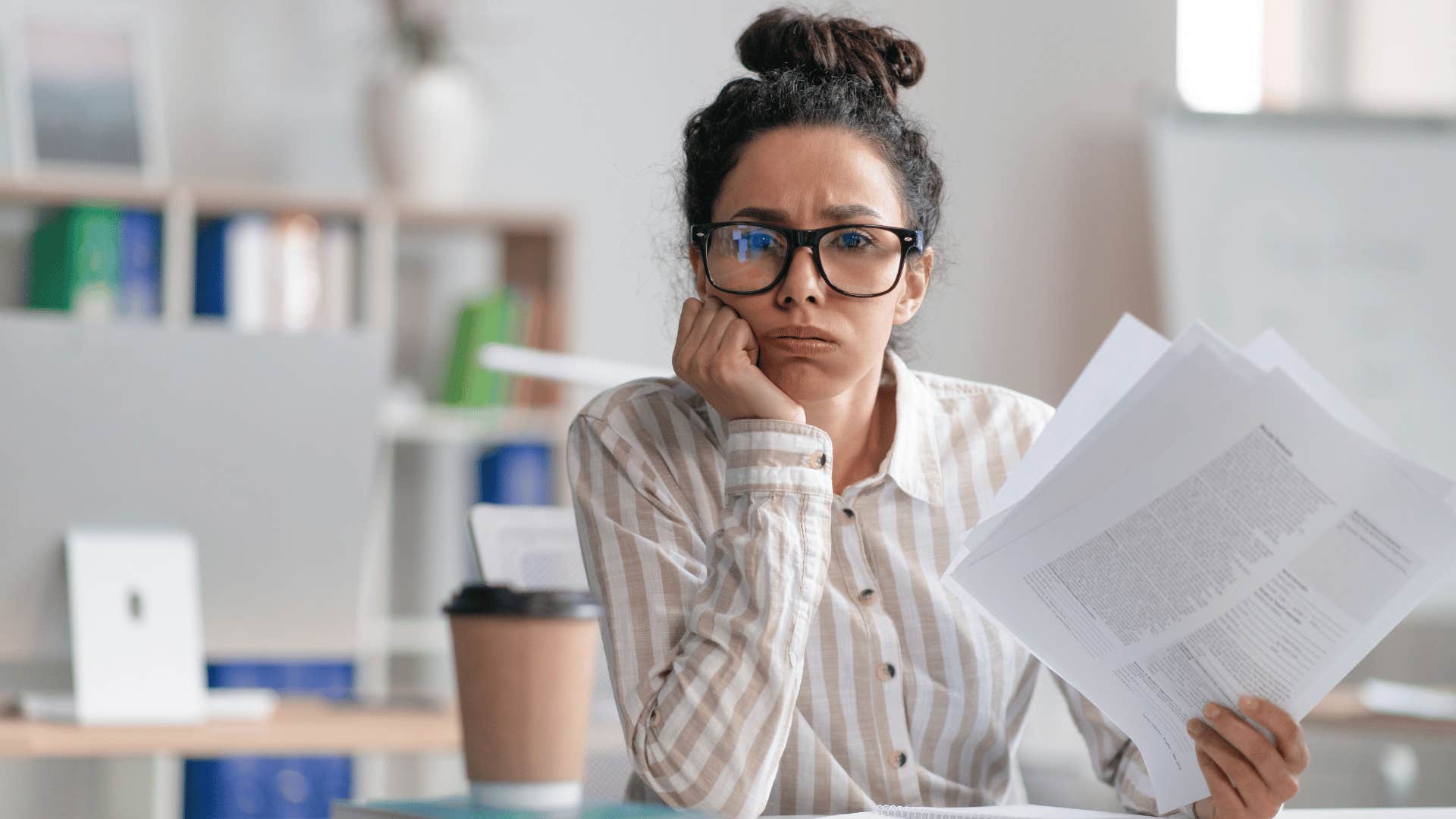 overwhelmed woman holding papers