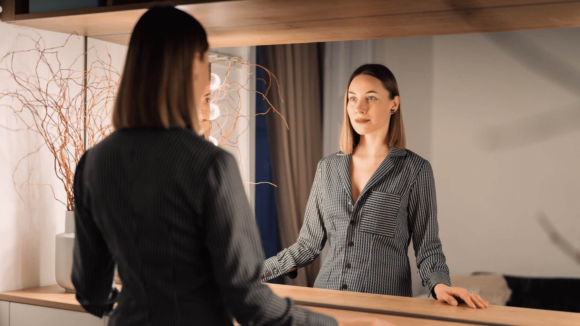 woman looking in the mirror