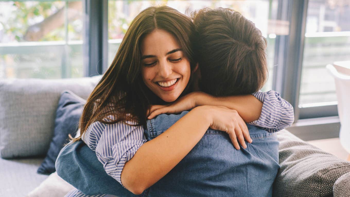 loving woman warmly embracing her husband