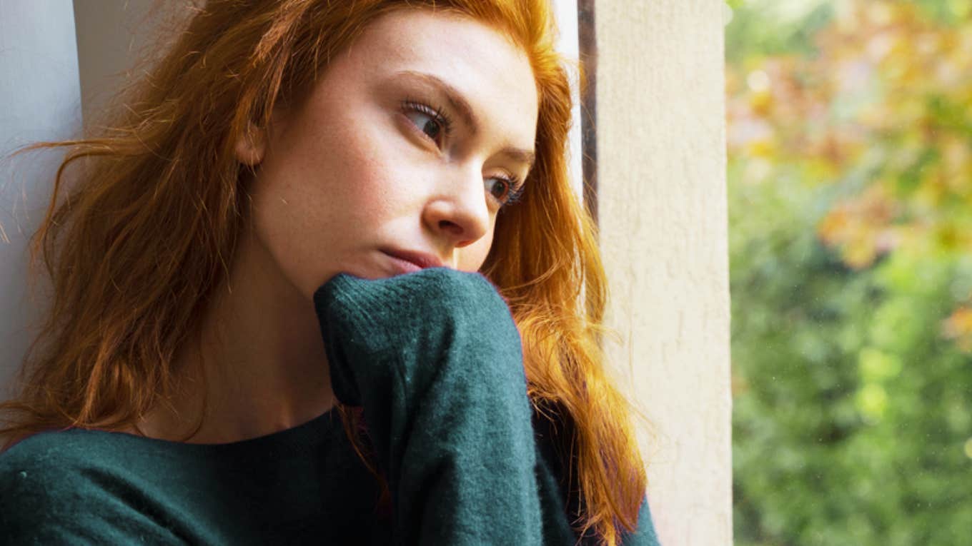 sad woman looking out window