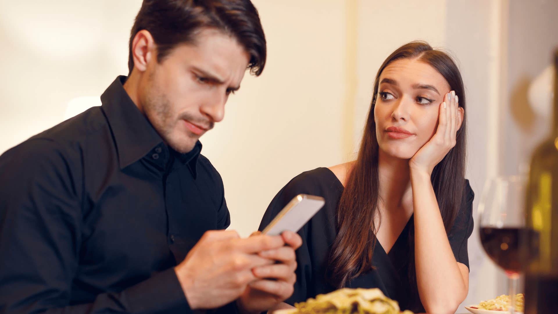 man ignoring woman on date