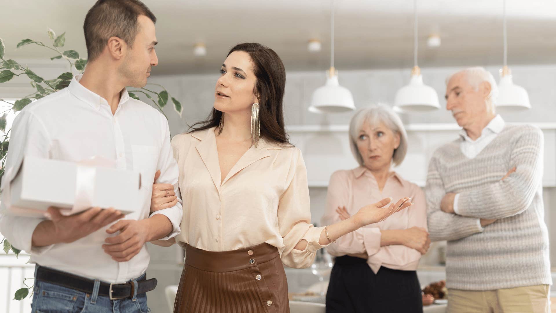 couple having a disagreement in front of parents