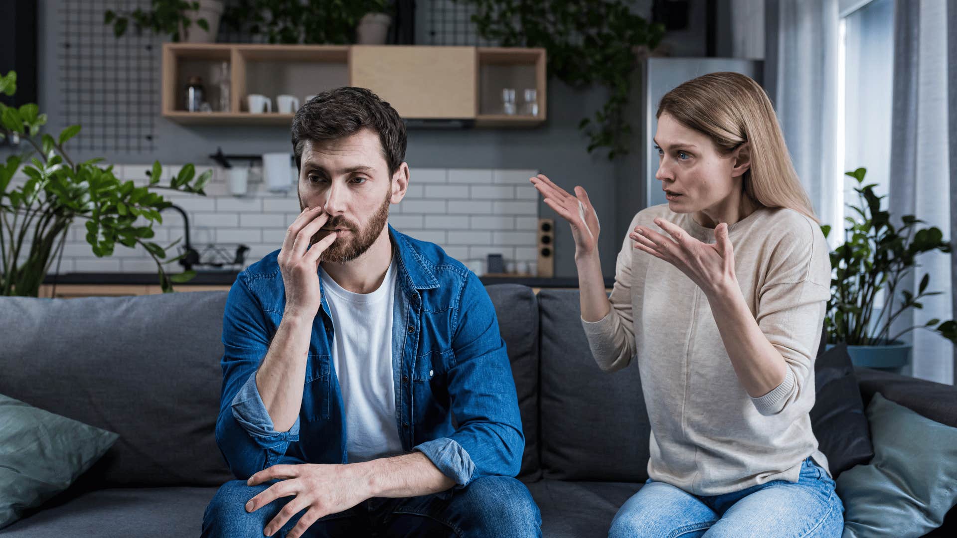 woman yelling at man on couch