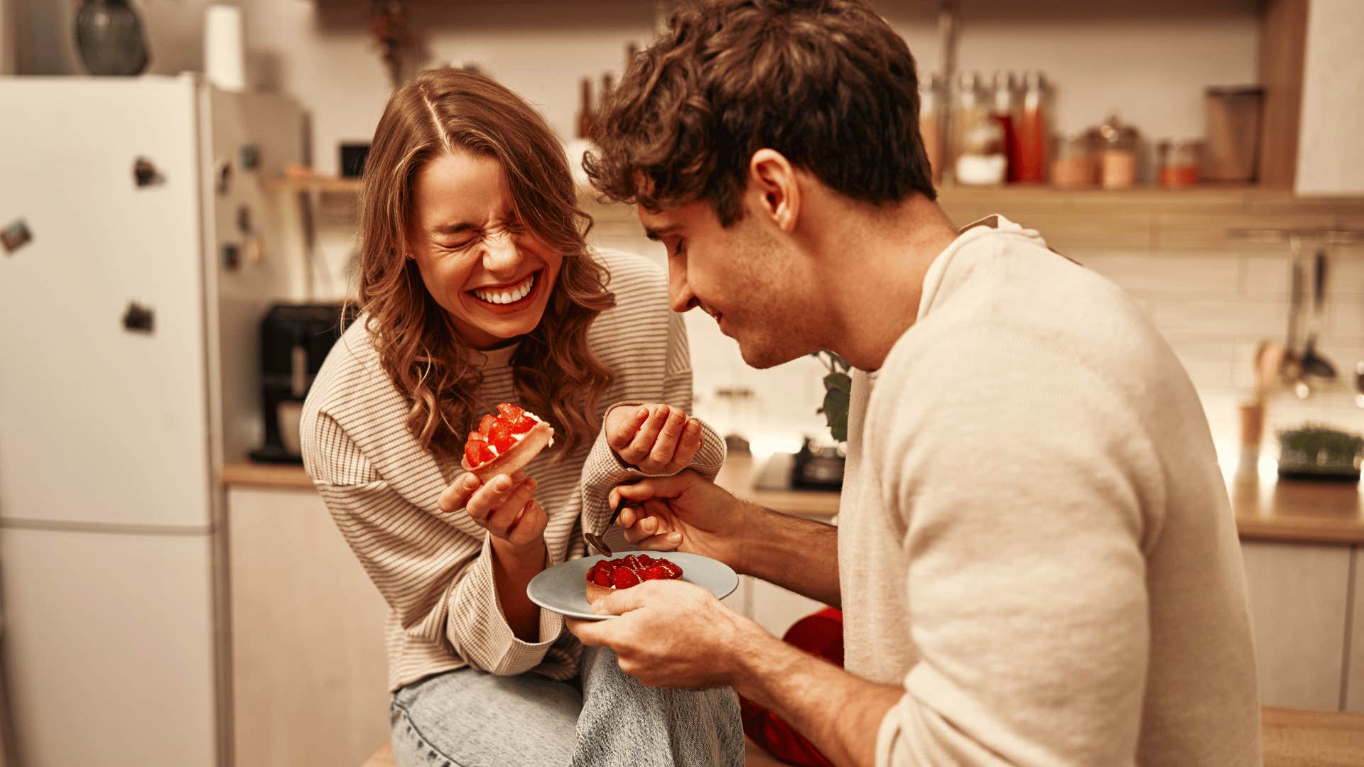 happy couple in kitchen sharing food