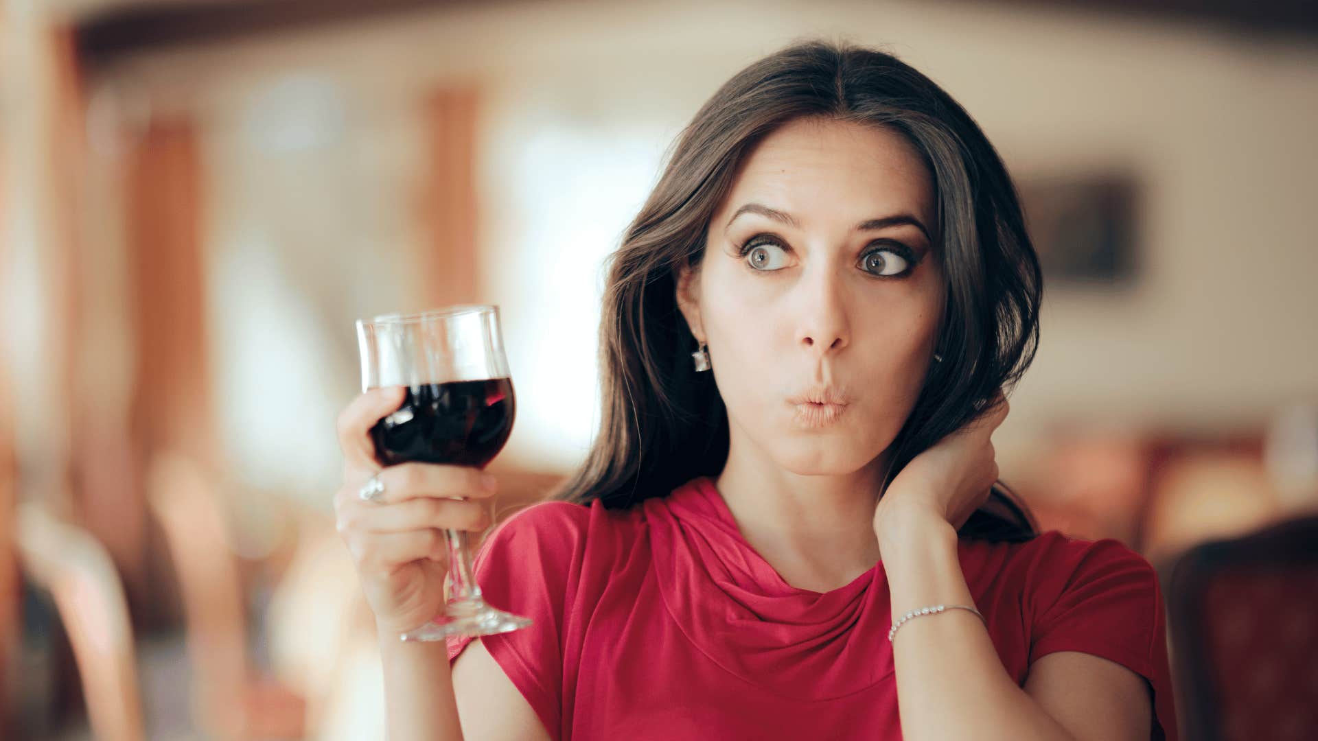 Woman drinking red wine about to be rude