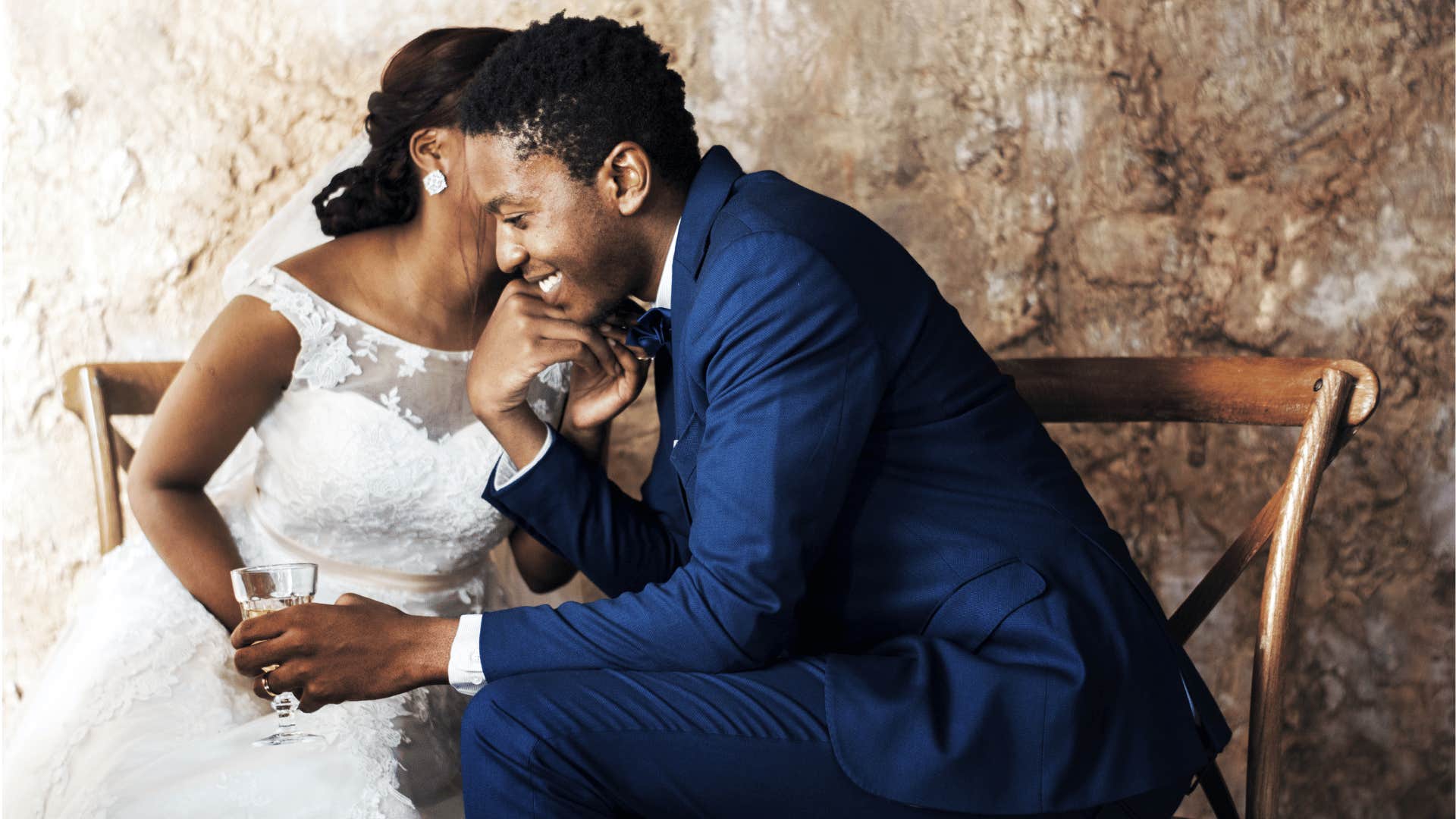 Bride whispers in groom's ear, they are the center of attention