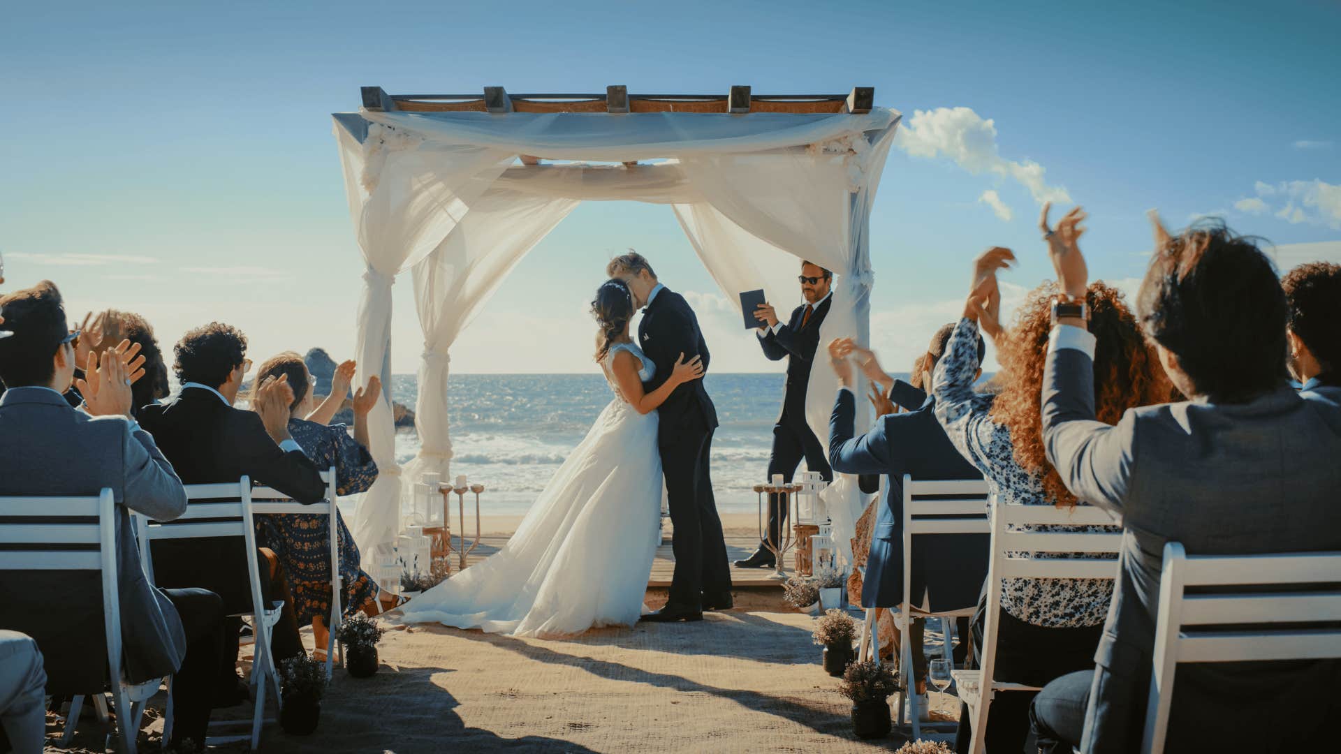 Bride and groom kiss, no guests are standing