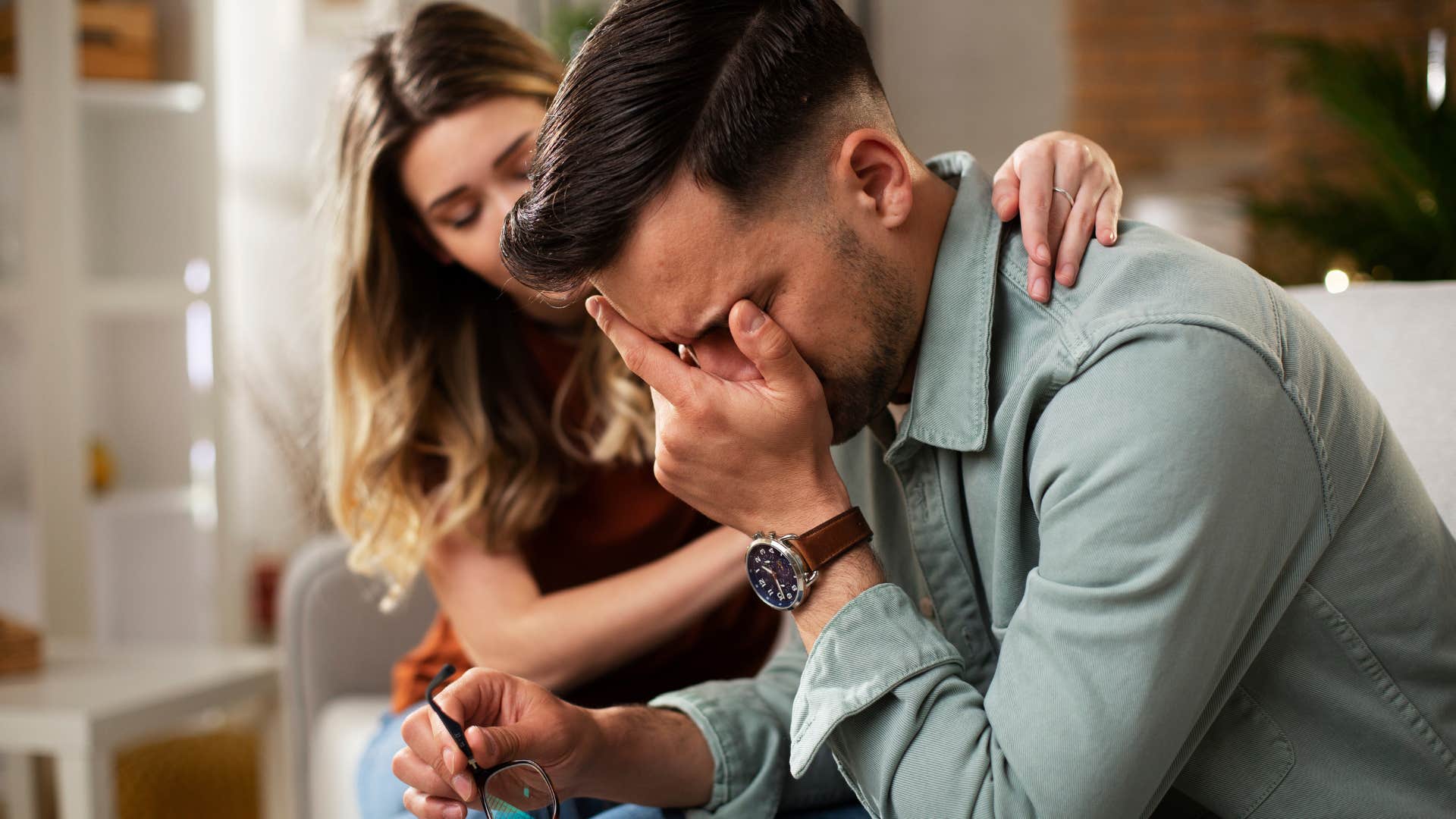 man playing the victim as woman comforts him