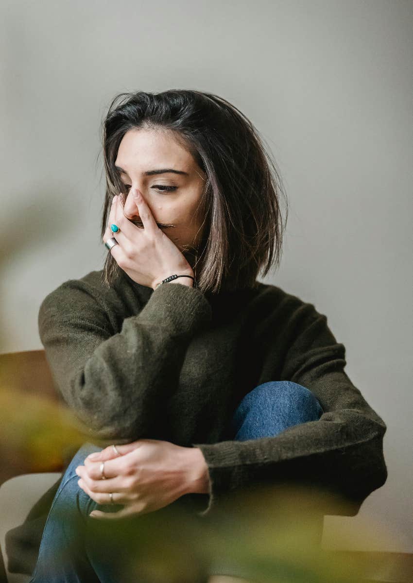 sad woman sitting with her legs pulled up