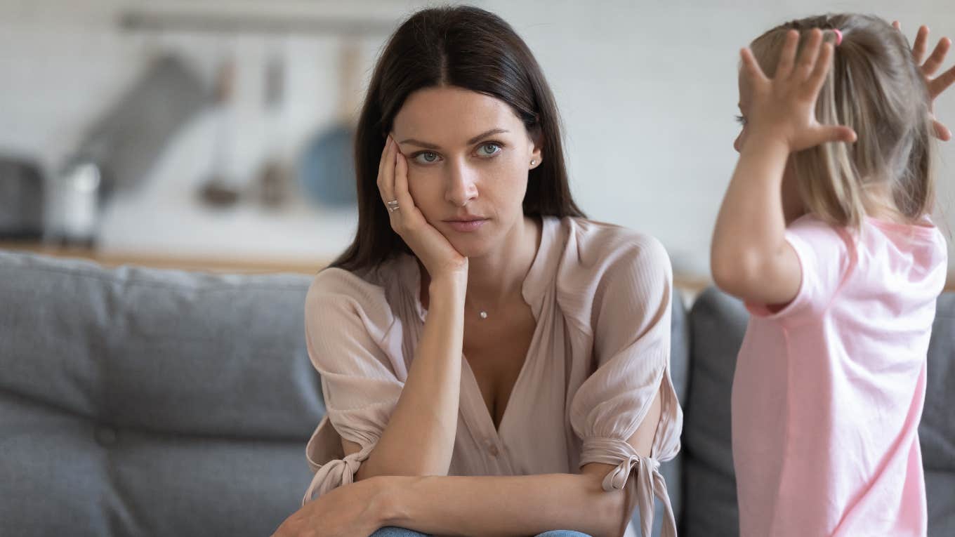 Mom watching her child throw a tantrum