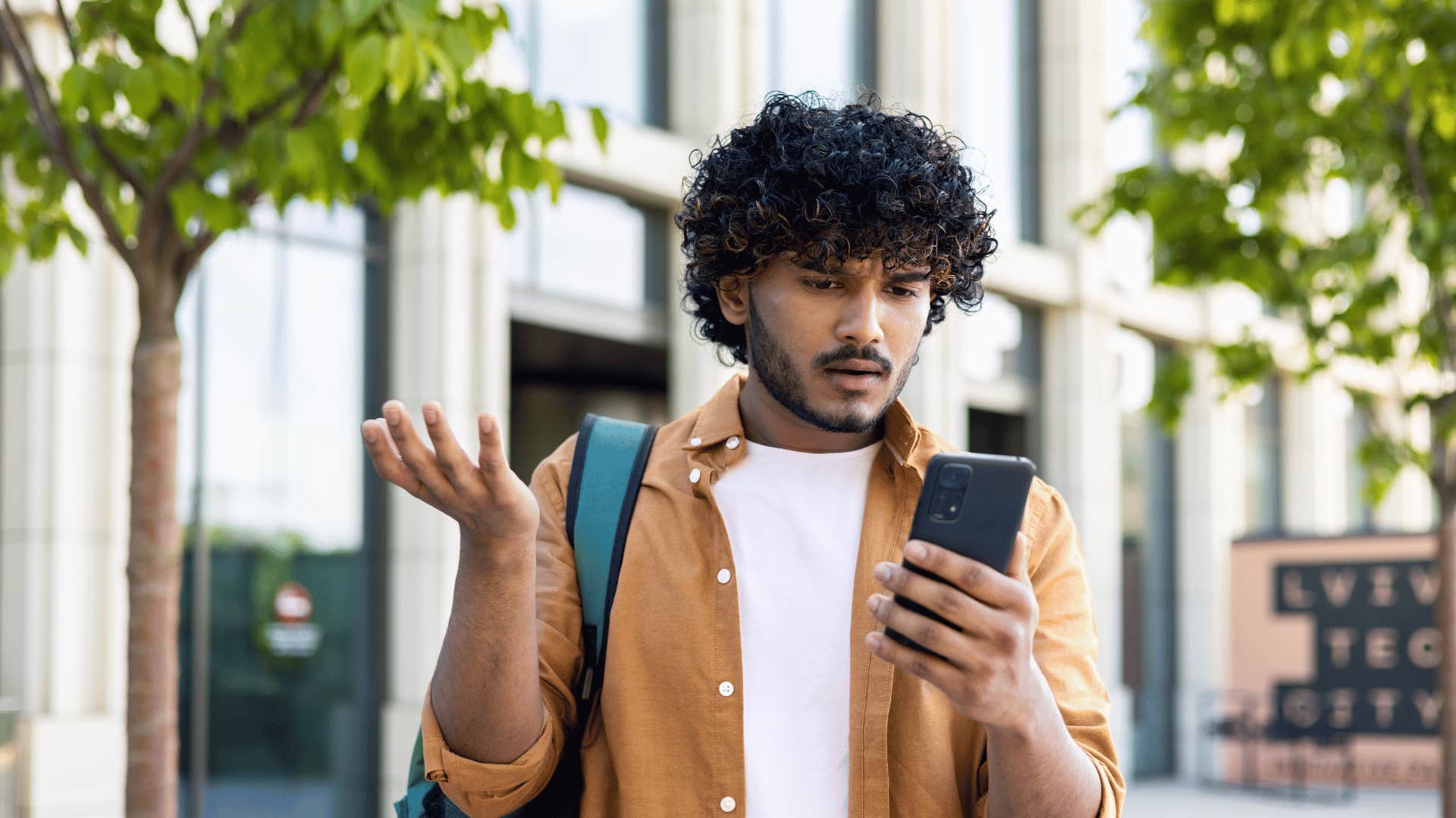 upset man looking at phone