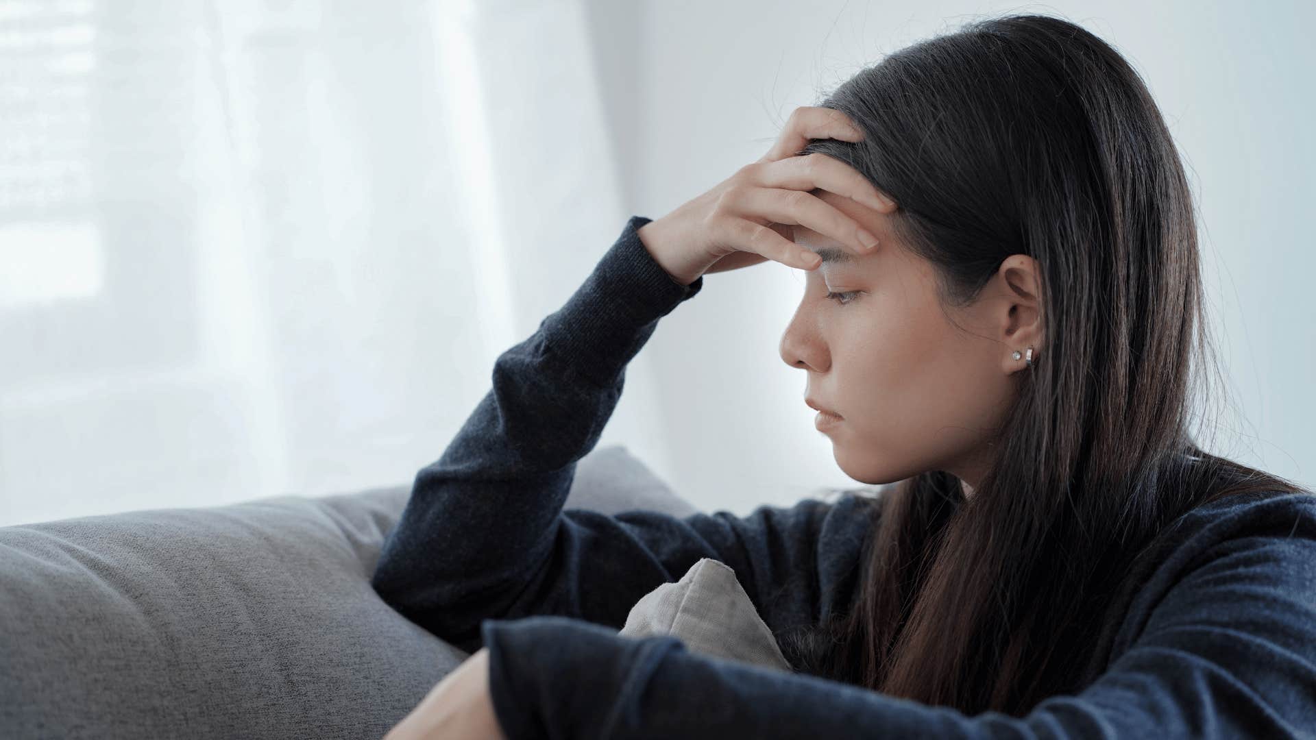 upset woman sitting on couch