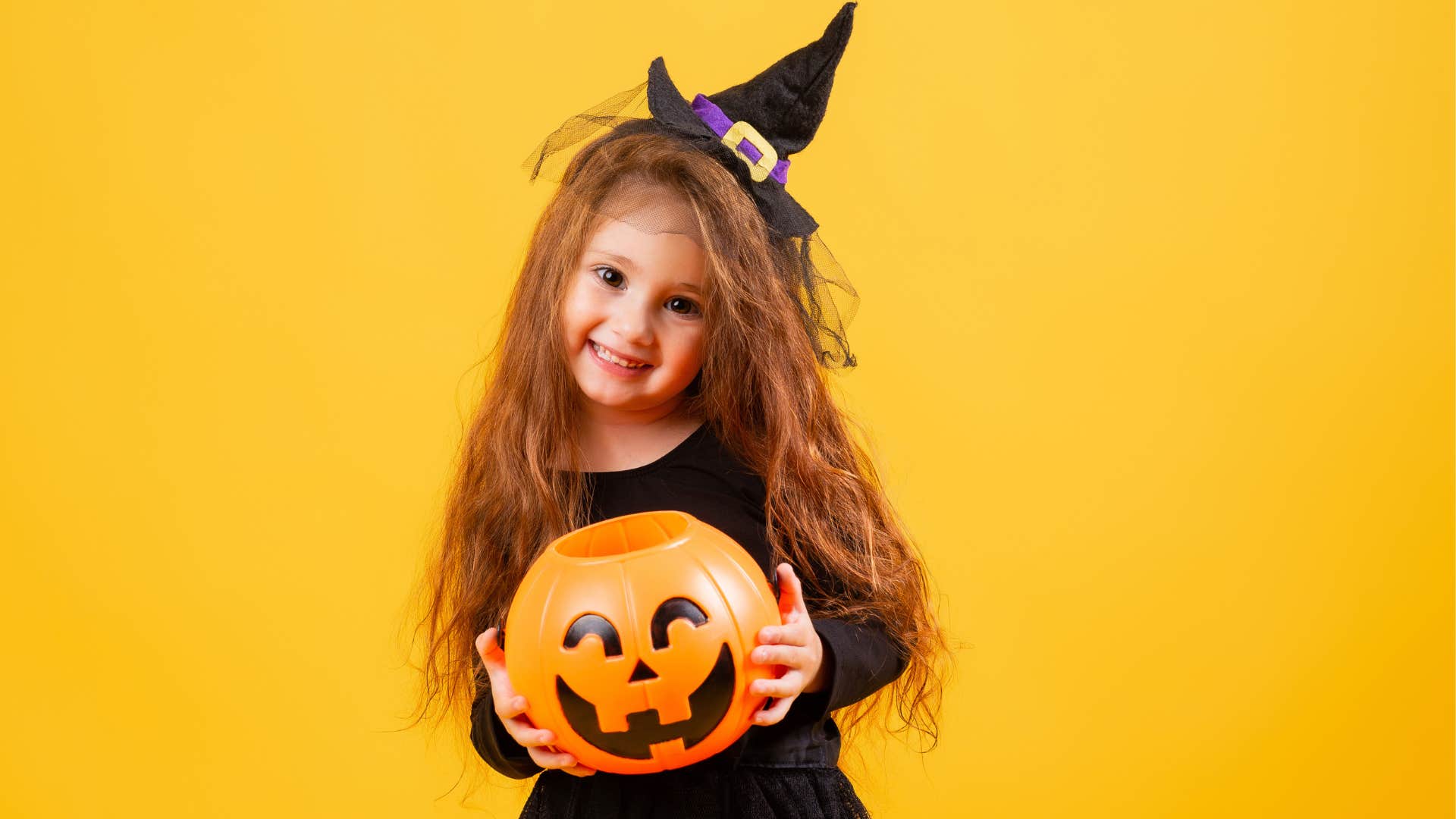 only child holding Halloween candy