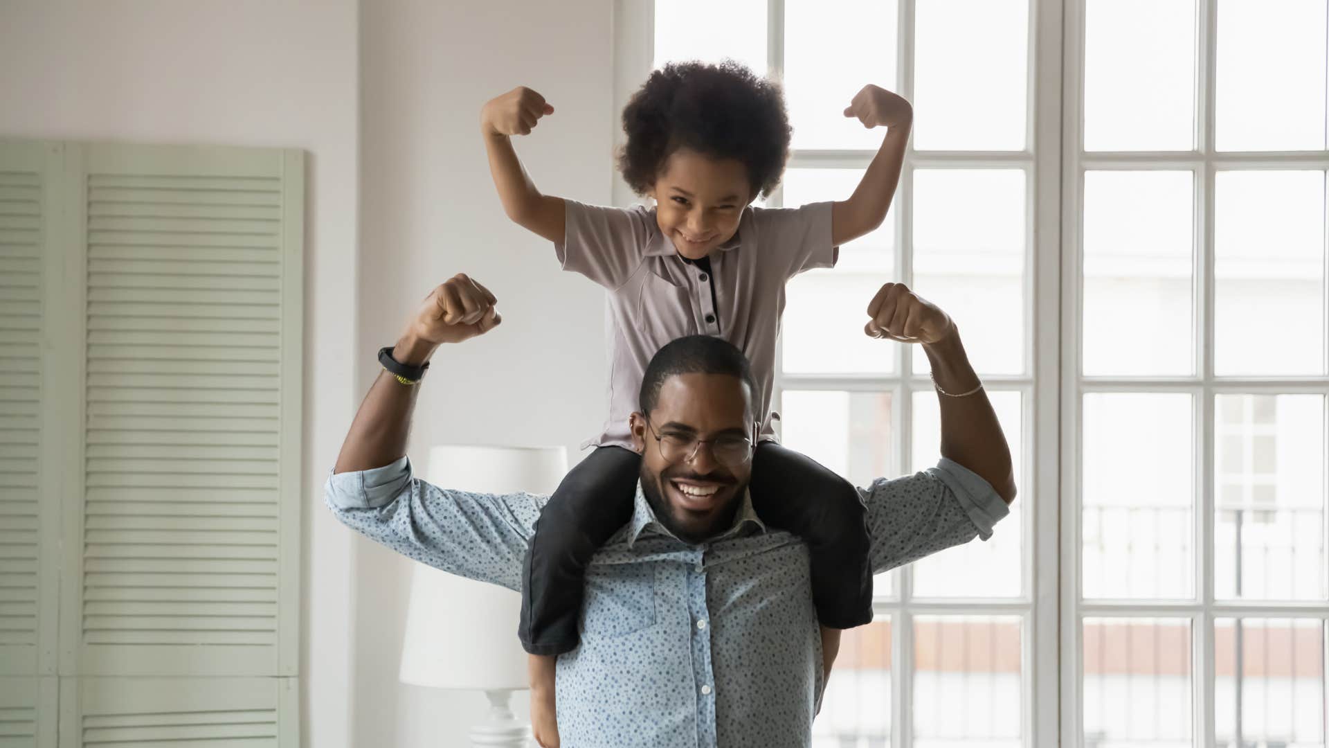 little boy and dad showing off muscles