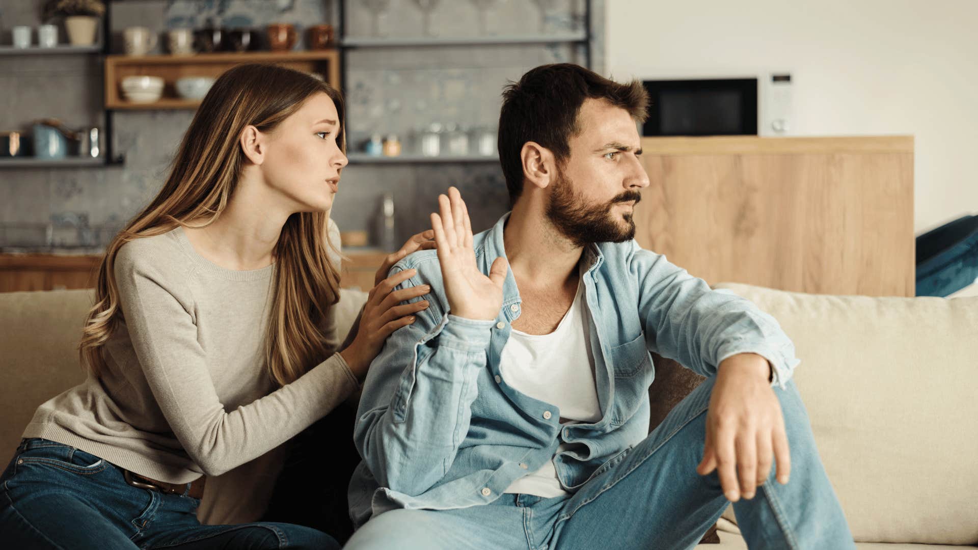 man ignoring woman talking