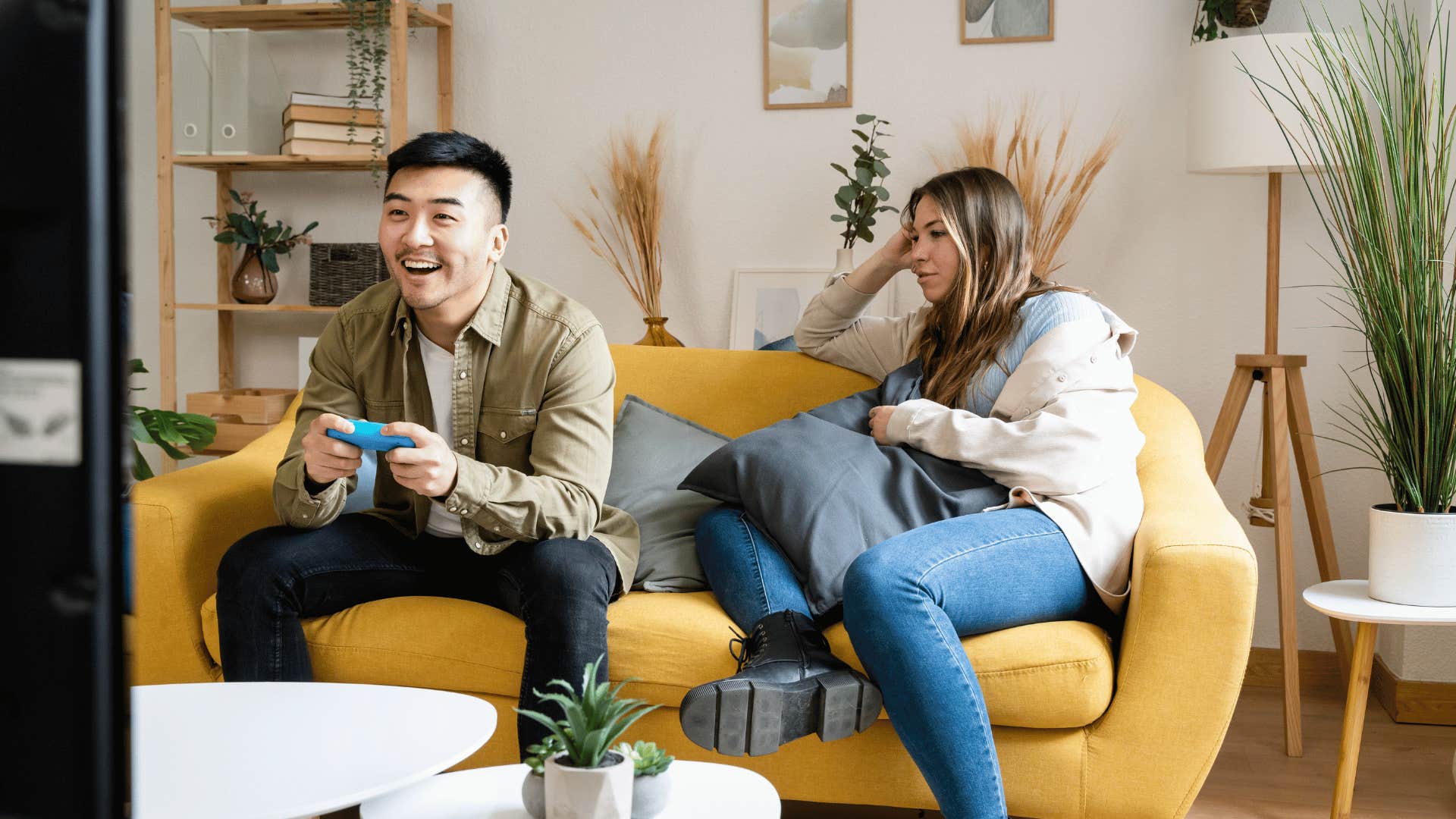 man ignoring woman on couch