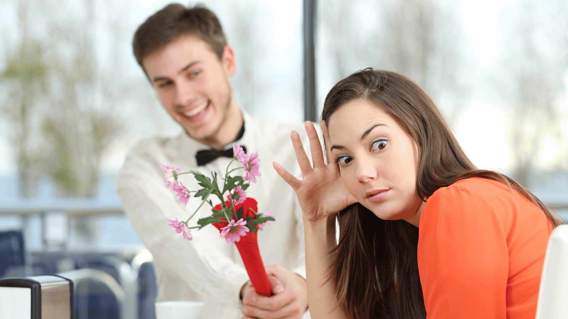 woman ignoring man with roses