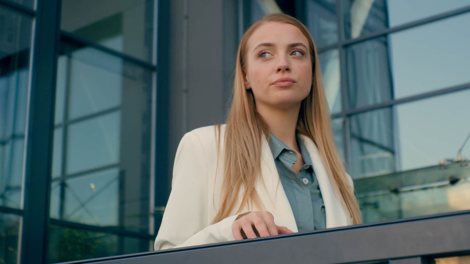 detail-oriented intelligent woman looking over balcony