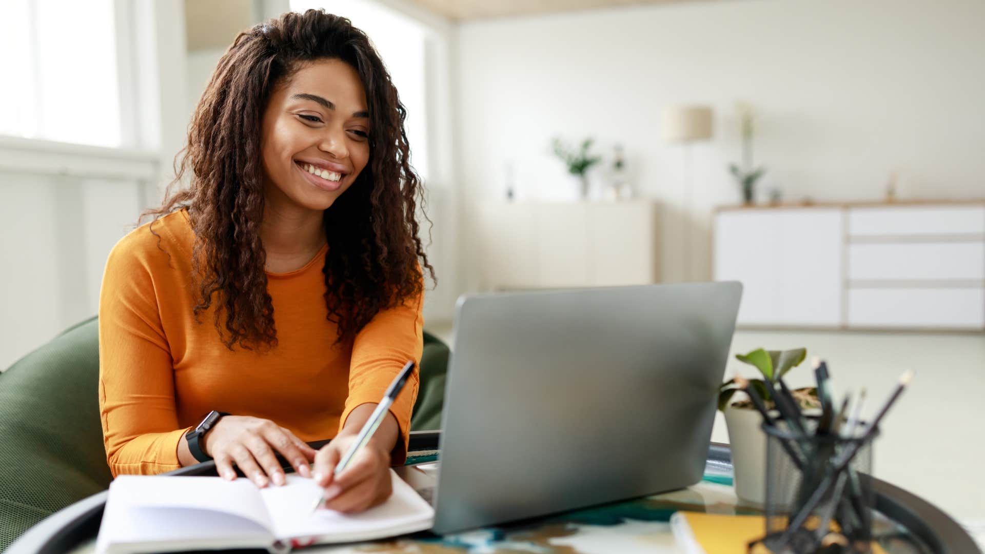 young woman writing in notebook