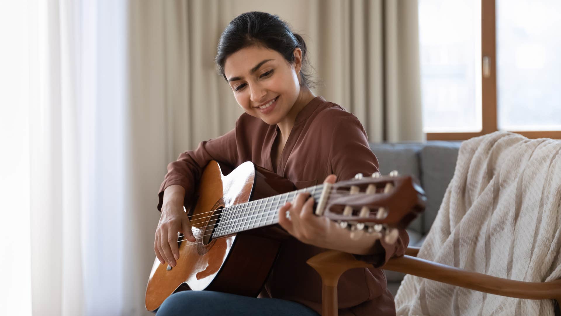 intelligent woman playing guitar